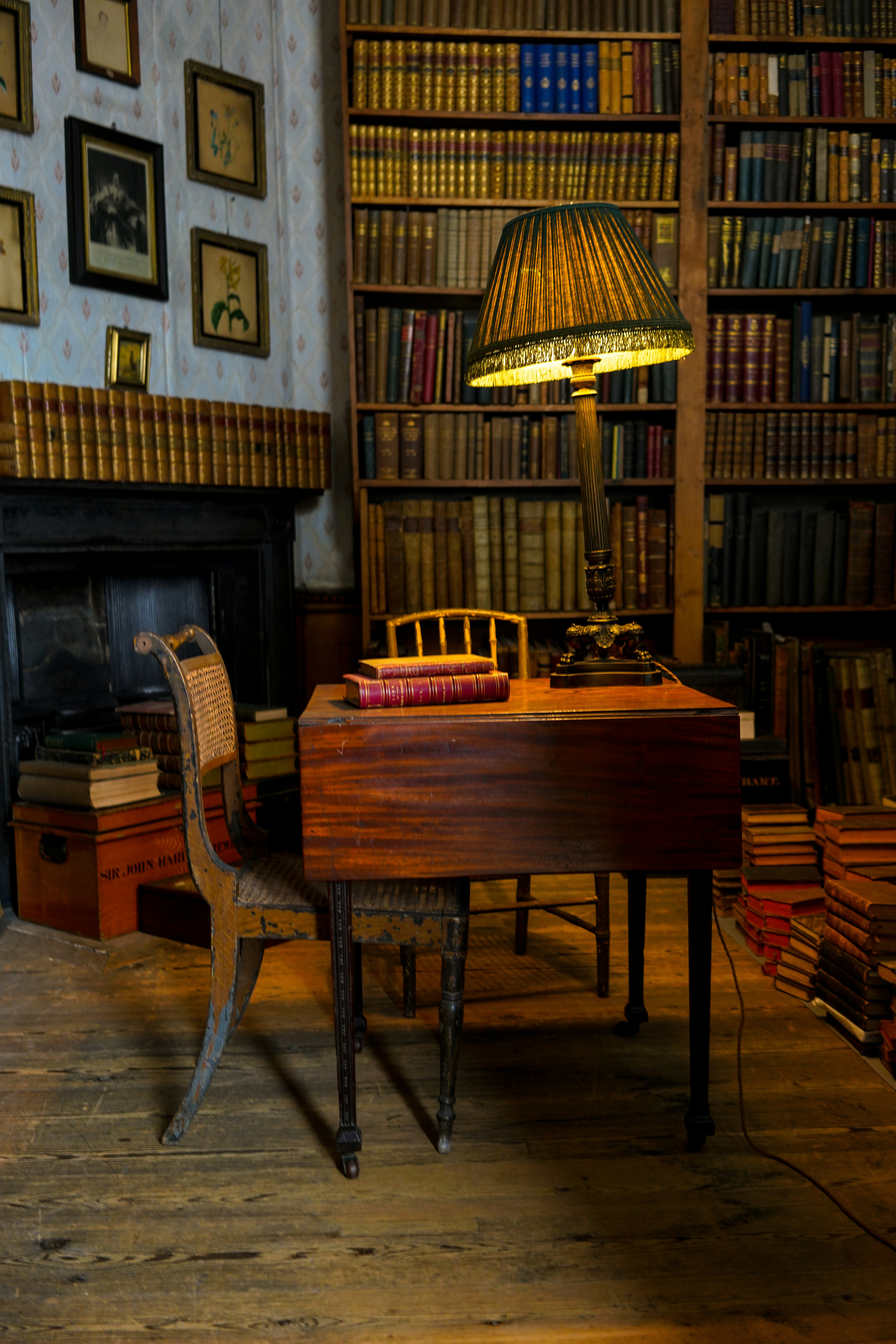 Classic vintage library with leather-bound books and warm lamp